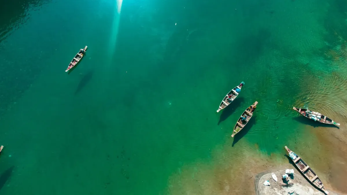 Aerial view of small boats on the turquoise water of the Umngot river near Dawki