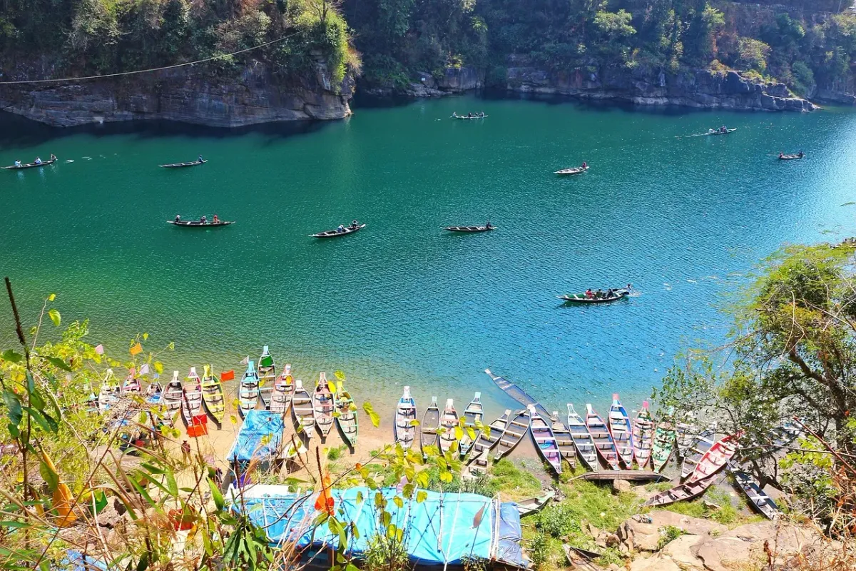 Dozens of tourist boats crowded along the bank of the Umngot river at the main Dawki boat point