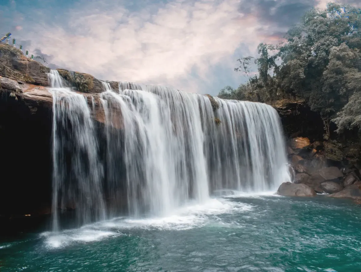 Krang Suri falls dropping into a deep blue-green pool